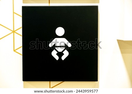 Bautzen, Saxony - Germany - 04-10-2021: Back and white Sign for baby diaper changing facility with iconographic imagery