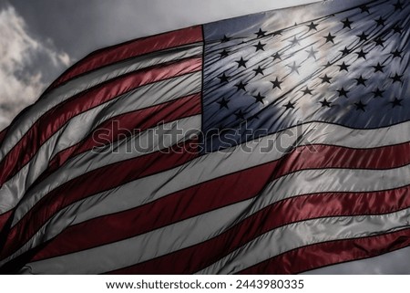US Flag. Waving american flag on dark dramatic sky. USA flag. Grunge American flag.