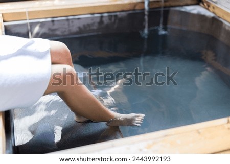Woman enjoy her hot spring at winter time Royalty-Free Stock Photo #2443992193