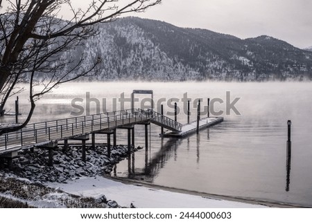 Mist rises from Lake Chelan around the Manson Pier and Jetty during a winter cold snap Royalty-Free Stock Photo #2444000603