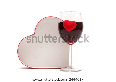 Red heart and glass of wine on a white background