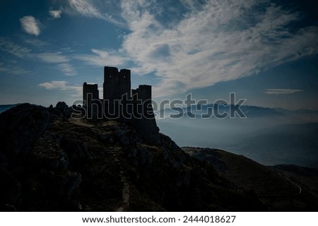 backlight OF THE FAMOUS FORTRESS OF ROCCA CALASCIO IN ABRUZZO. Royalty-Free Stock Photo #2444018627