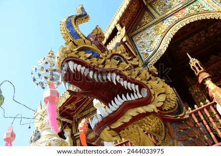 Carving sculpture ancient naga or antique naka statue for thai people travelers travel visit respect praying blessing wish myth holy mystery mystical at Wat Ming Mueang temple in Chiang Rai, Thailand