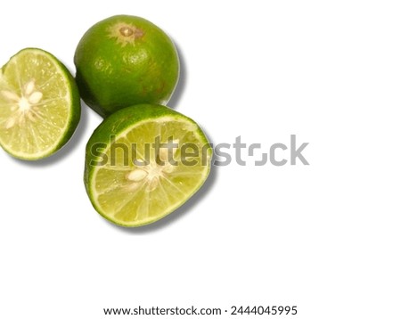 Two green limes whole and cut in half  isolated on white background
