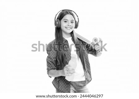 Teen girl 12, 13, 14 years old with skateboard and headphones over white studio background. Cool modern teenager in stylish clothes. Teenagers lifestyle, casual youth culture.