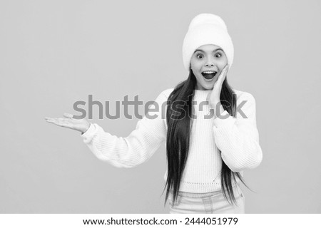 Excited face. Close-up portrait of her she nice cute attractive cheerful amazed girl pointing aside on copy space isolated on yellow background. Amazed expression, cheerful and glad.