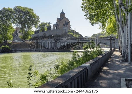 Awesome view of the Virgin Mary Assumption Church of Metekhi and the Metekhi Bridge over the Kura (Mtkvari) River in Old Town of Tbilisi, Georgia. Tbilisi is a popular tourist destination. Royalty-Free Stock Photo #2444062195