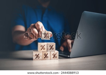 interest, percent, increase, mortgage, profit, strategy, financial, risk, success, investment. A man is holding a stack of wooden blocks with a sign that says percent on it.