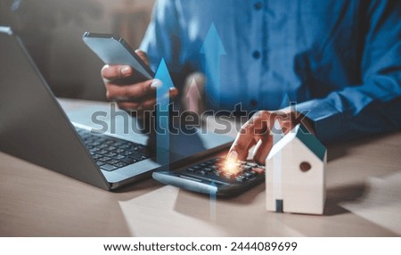 marketing, investment, meeting, planning, profit, strategy, social, financial, analysis, finance. A man is using a laptop and a calculator to calculate the cost of house. Concept of financial planning