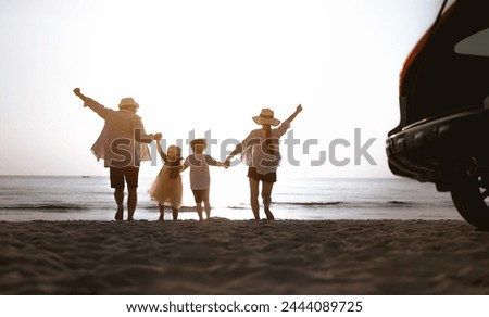 family, parent, beach, walking, sunrise, silhouette, together, freedom, childhood, relaxation. A family is playing on the beach, with a car in the background, as the family enjoys their time together.