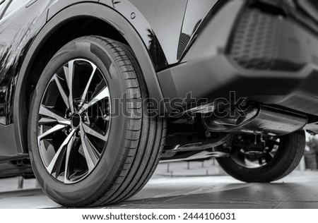 black Car in showroom. Aluminum wheel with  Tire. automobile wheel tire.  aluminium rims. Motor Corporation is Japanese automotive manufacturer. 4Ñ…4. 4wd. 