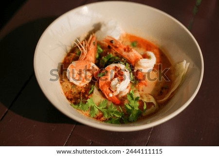 selective focus shrimp looks delicious in a bowl of tom yum shrimp noodles Placed on the table to decorate the table. cooking ideas