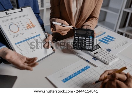 A group of business people are discussing company figures to resolve quarter of the year's losses, A group of employees is meeting to come up with a strategy to increase profits for the company. Royalty-Free Stock Photo #2444114841
