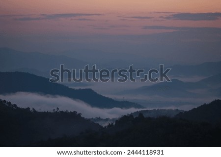 Background image of a morning landscape on a mountaintop with mountains and a sea of ​​mist before the sun rises. There is space for text.