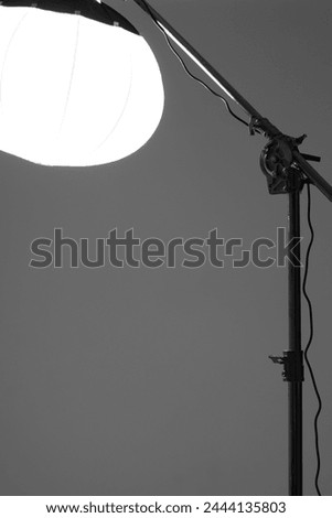 Photo Studio. Lantern Modifier on Crane Light Stand on Studio Cyclorama. Fashion Shoot. Royalty-Free Stock Photo #2444135803