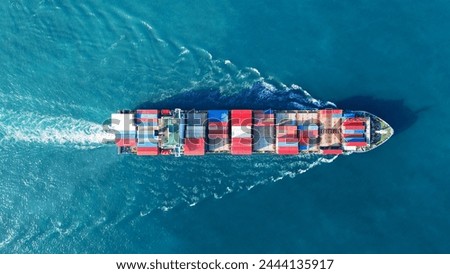 Aerial view of cargo ship with contrail in the ocean sea ship carrying container and running from container international port smart freight shipping by ship service
