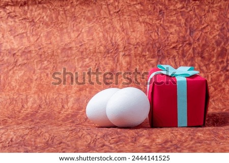 Gift boxes and white easter eggs on a background of brown paper. Happy Easter concept.