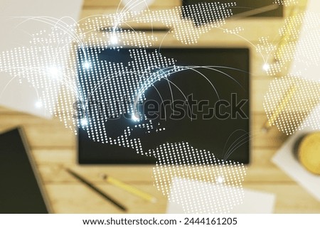 Double exposure of abstract digital world map with connections and digital tablet on background, top view, research and strategy concept
