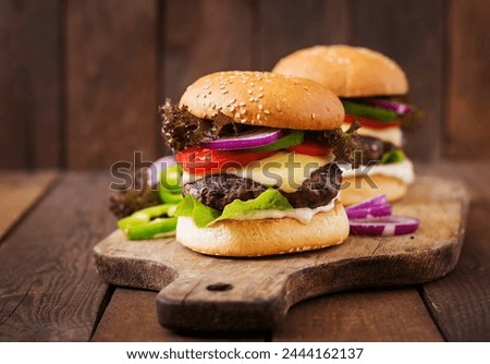 A hommade hamburger with beef patty, vegetables, and cheese cooked in professional kitchen of italian restaurant
