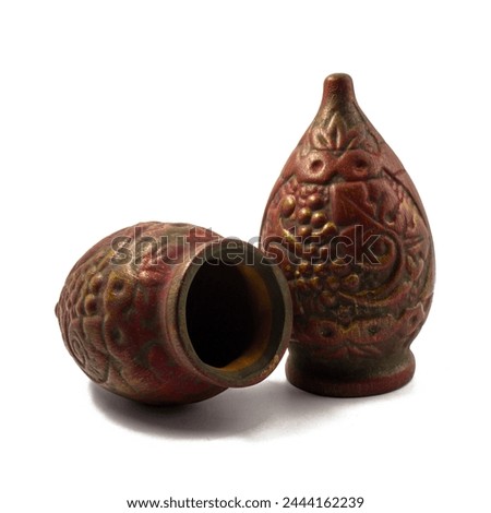 Two Souvenir Qvevri (Kvevri) made of clay for drinking wine. Bas-reliefs in the form of a grapevine. Kvevri are earthenware vessels used for 
the fermentation, storage and ageing of Georgian wine. Royalty-Free Stock Photo #2444162239