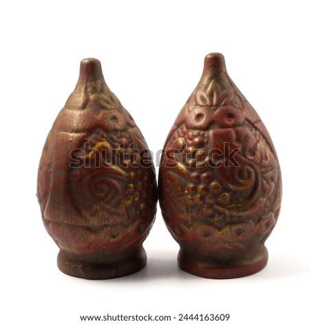 Two Souvenir Qvevri (Kvevri) made of clay for drinking wine. Bas-reliefs in the form of a grapevine. Kvevri are earthenware vessels used for 
the fermentation, storage and ageing of Georgian wine. Royalty-Free Stock Photo #2444163609