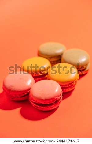 colorful macarons  cookies  on orange background