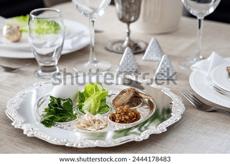 Festive Passover table setting . Pesach celebration	 Royalty-Free Stock Photo #2444178483