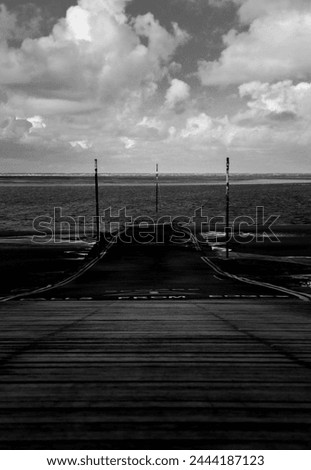 Black and white image of a boat ramp