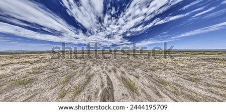 Panoramic picture over the Namibian Kalahari with blue sky and light clouds in summer
