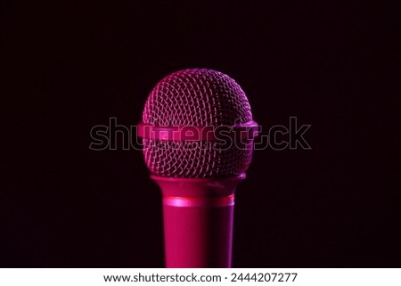 Modern microphone on dark background, closeup