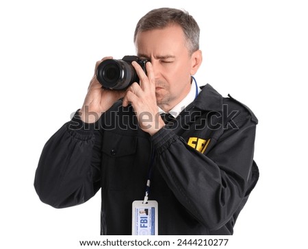 Mature FBI agent with photo camera on white background