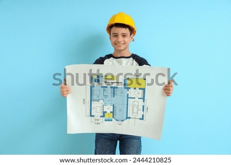 Little architect with house plan on blue background