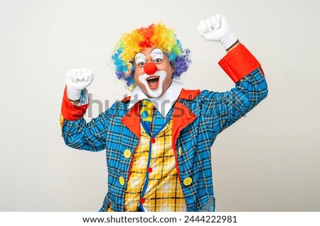 Laughing Mr Clown. Portrait of Funny happy face comedian Clown man in colorful costume wearing wig listen music. Happy expression amazed bozo dancing with music in various pose on white background.