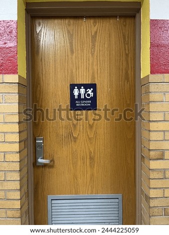 The entrance and sign to an all gender restroom.