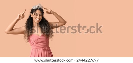 Beautiful young African-American girl in stylish prom dress and tiara on beige background with space for text