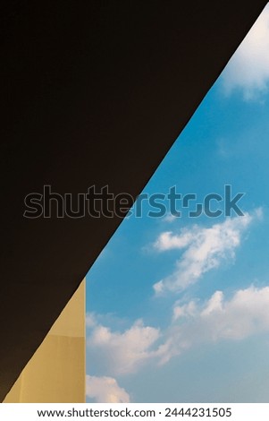detail of yellow building and blue sky for background, diagonal line, acute angle, composition emphasize perspective Royalty-Free Stock Photo #2444231505