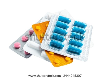 Various medicine capsules, pills and tablets in a blister pack isolated on white background, healthcare and medicine concept. Royalty-Free Stock Photo #2444245307
