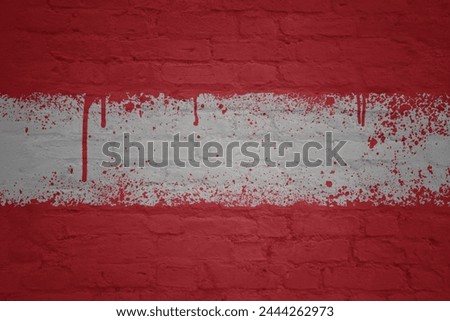 colorful painted big national flag of austria on a massive old brick wall