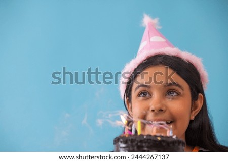 Close up of a cute little girl with birthday cake