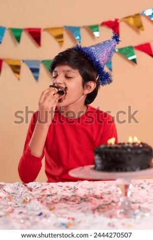 Portrait of boy eating his birthday cake