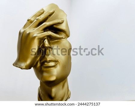 Headache. Golden human head. A man holding his head.