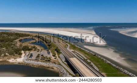Aerial shot of Highway A1A running through Jacksonville, flanked by the glistening Fort George River and Heckscher Drive.