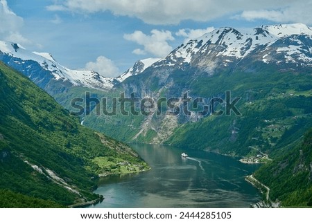 Beautiful Geiranger Fjord is a well known and popular travel destination for cruise ships and offers spectacular views to the norwegian landscape with deep gorges and snow covered mountain ranges. Royalty-Free Stock Photo #2444285105