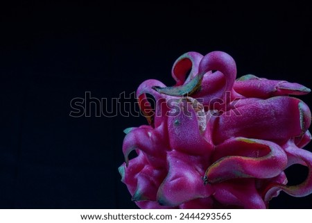 close up view of dragon fruit on black background