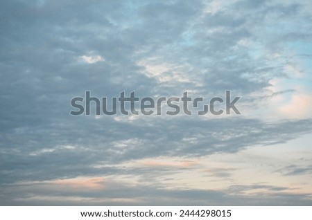 Cloudy vast sky. Slightly dim evening. Royalty-Free Stock Photo #2444298015