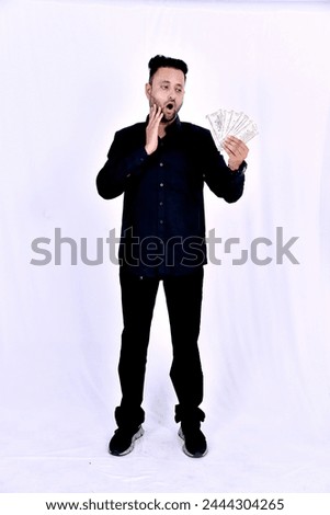 Indian young man showing bank note on white background