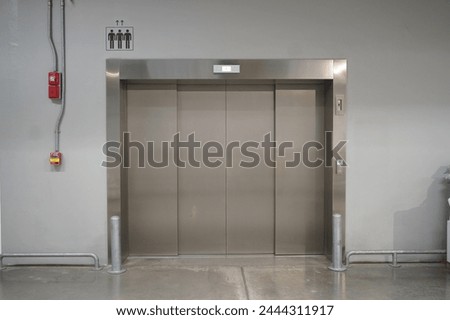 Front view of closed Passenger elevator inside the building with sign