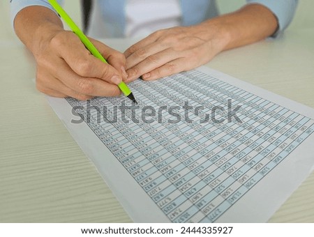 Business woman working with financial tables at the office desk. Method for identifying unreliable indicators in reporting Royalty-Free Stock Photo #2444335927