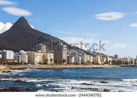 Scenic view of Sea Point Promenade with scenic view Seapoint district and Lion’s Head Peak, Cape Town, South Africa against blue sky Royalty-Free Stock Photo #2444340781