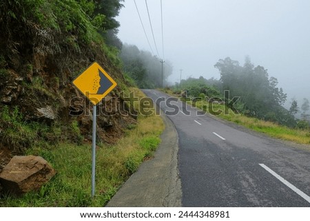 Landslide danger traffic signs on mountain roads. Landslide danger signs. yellow. foggy mountain roads. roads with cliffs prone to landslides